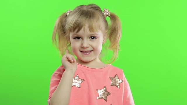 Positive child in pink blouse waving her hands and tells something. Chroma Key