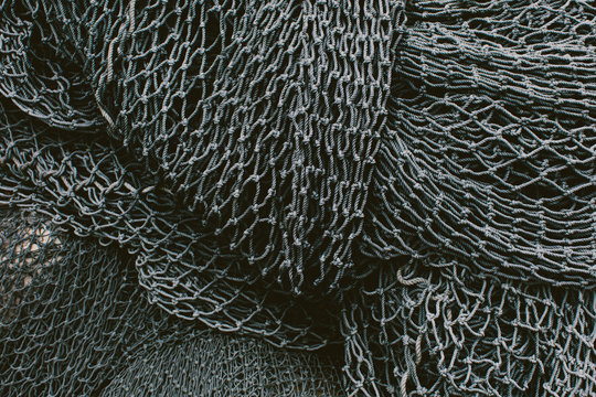 Pile of commercial fishing nets and gill nets on a fishing quay.,Seattle