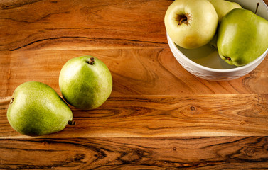 green apples in a bowl on wooden table