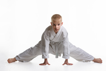 Karate boy tries to sit on a twine