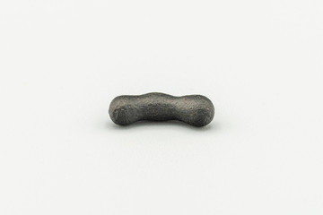 Black magnetic Atacaimite Tektite Meteorite isolated, a rock formed in a big meteorite collision at...