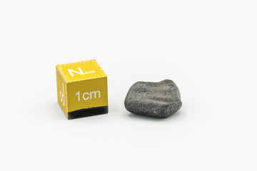 Black magnetic Atacaimite Tektite Meteorite isolated, a rock formed in a big meteorite collision at...