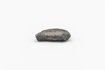 Black magnetic Atacaimite Tektite Meteorite isolated, a rock formed in a big meteorite collision at...