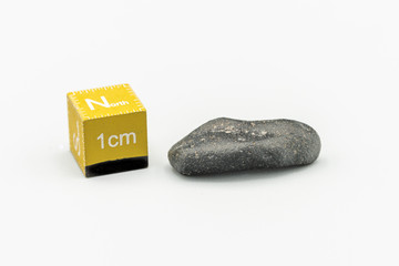 Black magnetic Atacaimite Tektite Meteorite isolated, a rock formed in a big meteorite collision at...
