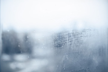 Texture. Foggy window with flowing water droplets. Can be used as a background.