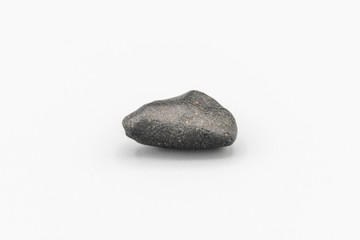 Black magnetic Atacaimite Tektite Meteorite isolated, a rock formed in a big meteorite collision at...