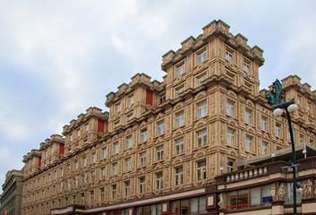 Low angle view of the Adria Palace under a cloudy sky in Prague in Czechia