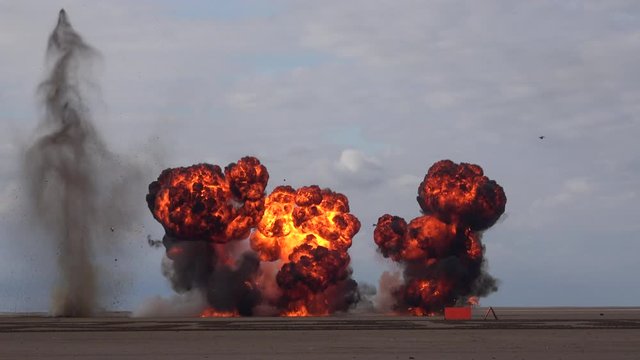 Explosion from bomb in the sand fire and smoke UK 4K
