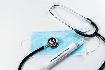 Coronavirus Covid-19 prevention. Blue medical disposable mask, stethoscope and corona virus test. Wuhan pandemic. White background isolated with copyspace