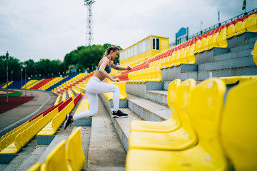Fit female training on stairs at stadium