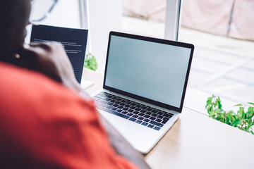 Unrecognizable person working on laptop in office