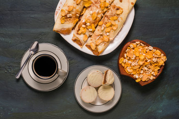 Argentinian traditional breakfast with pancakes and Alfajores
