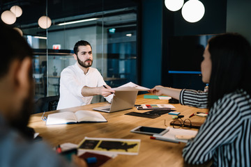 Confident group of colleagues work on business project in office