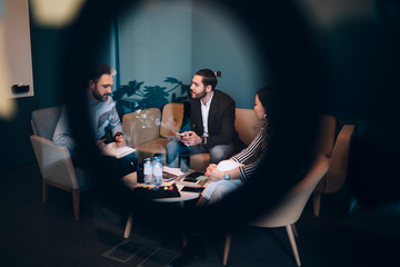 Successful group of coworkers discuss business ideas in rest room