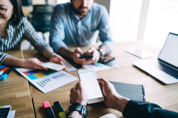 Coworkers using different devices in office