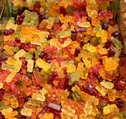 Candies of different types and colors close up. Photographed in front of the store.