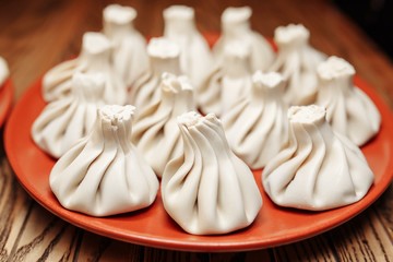 cooked khinkali on a clay plate