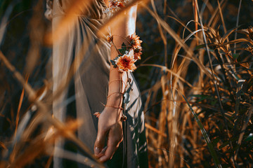 close up of young and tender woman shoulder in setting sun rays of light