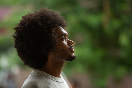Close-up side view of thoughtful businessman with afro hair at office