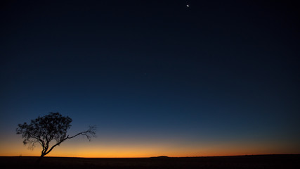 The sun sets behind a rise near Middleton, Queensland