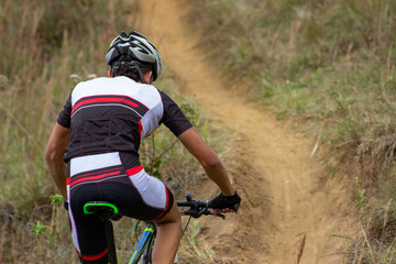 back biker man in competition with mountain background