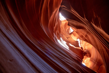 Obraz premium Unique & stunning Antelope Canyon located near Page, Arizona. Looking up into the famous tourist area during summer time with sun shining down through canyon walls 