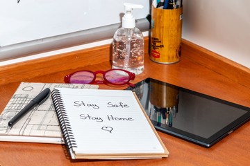 Stay safe sign, work from home. with various office objects The office is closed. Pandemic Covid-19...