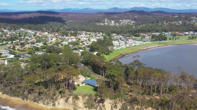 Panoramic aerial drone view camera pan Corrigans Beach to Caseys Beach at Batemans Bay on the New South Wales South Coast, Australia, on a sunny day  