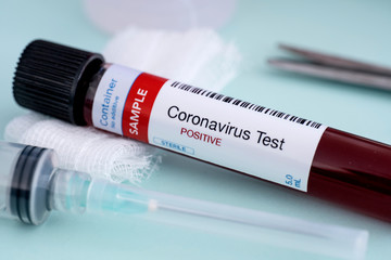 Testing for presence of coronavirus. Syringe with vaccine and tube containing a blood sample that has tested positive for COVID-19.