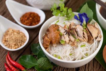 Chicken noodle in a bowl with side dishes, Thai food