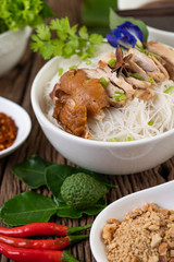 Chicken noodle in a bowl with side dishes, Thai food