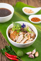 Chicken noodle in a bowl with side dishes, Thai food
