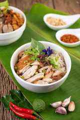 Chicken noodle in a bowl with side dishes, Thai food