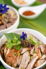 Chicken noodle in a bowl with side dishes, Thai food