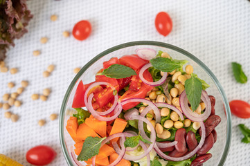 Fruit and vegetable salad in a glass cup on a white ground