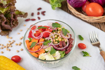 Fruit and vegetable salad in a glass cup on a white ground