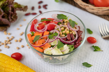 Fruit and vegetable salad in a glass cup on a white ground