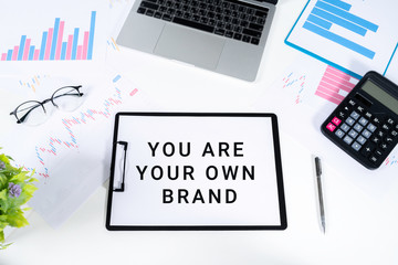 Obraz premium Top view of documents written with YOU ARE YOUR OWN BRAND Brand Building concept.