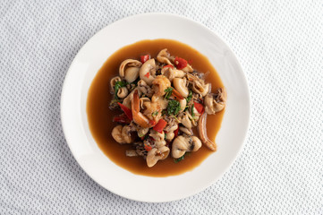 Stir fried basil with squid and shrimp, seafood style Thai food.