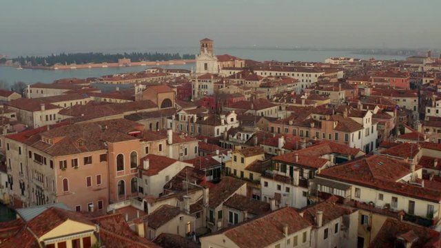Aerial, drone shot overlooking buildings and Venetian architecture, evening, in Venice, Italy