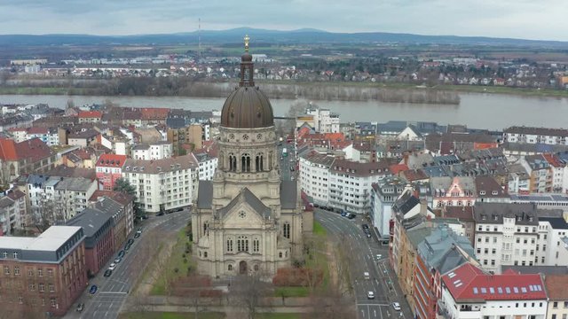 Aerial cinematic shot of the christus church in mainz with the river rhine in the background 30p