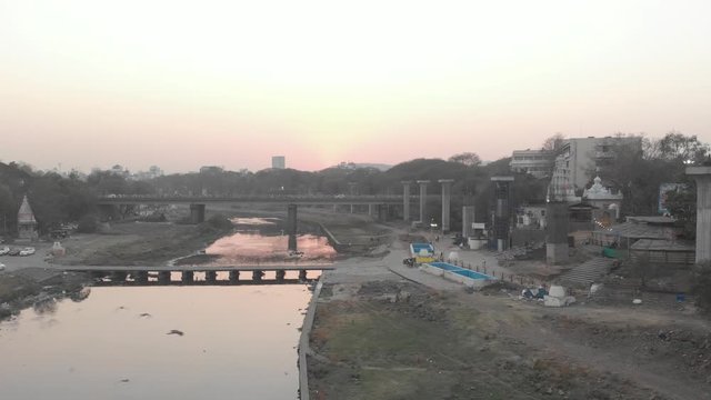 Rising drone shot over Pune city at sunset
