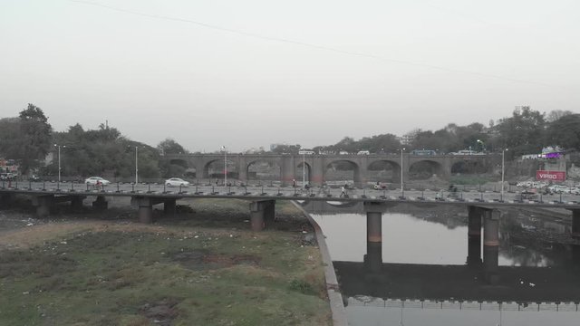 Steady shot of a small road bridge over a river