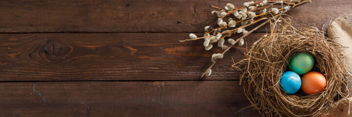 Still life of easter eggs in a bird's nest on a wooden background. Rustic. Decoration of natural....