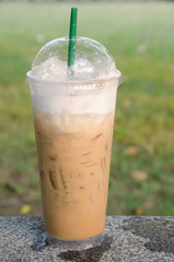 Iced coffee on the marble table in the park