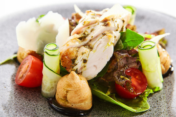 Salad with cheese profiteroles and sous vide chicken