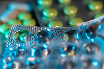 Pill package with pills in the background. Health and wellbeing medication. Medicine and cures for sickness