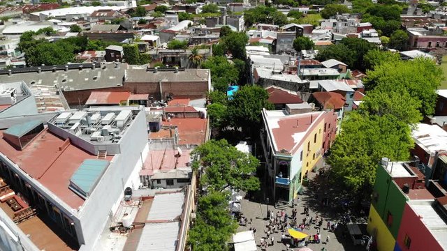 Aerial view of Caminito a famous landmark in La Boca neighborhood in Buenos Aires, Argentina. Drone flying forward