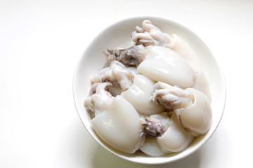 Raw Cuttlefish or Cuttlefish Rainbow in a bowl isolated on white background.