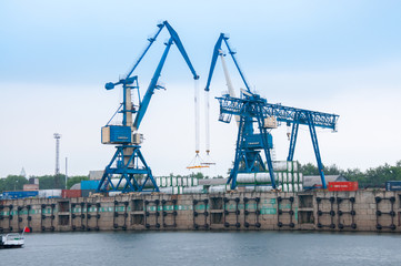 Obraz premium Russia, Blagoveshchensk, July 2019: River station, cranes for loading operations, Blagoveshchensk in summer